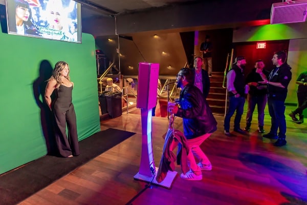 a women having her photo taken in a  AI photo booth