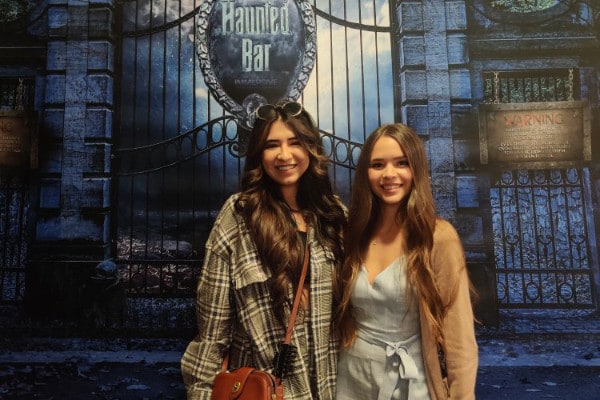 Girls in front of tombstone